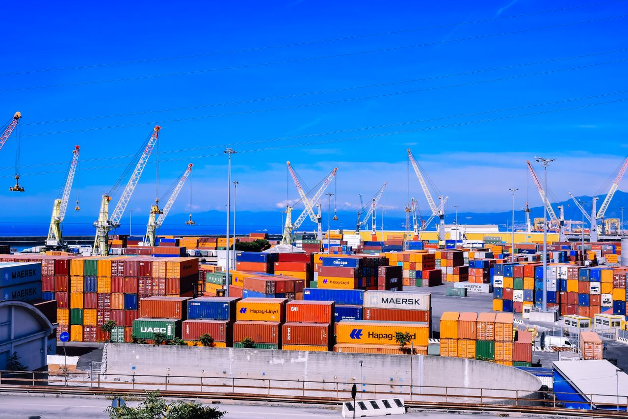 A large cargo truck travels on a highway in Brazil under clear blue skies.